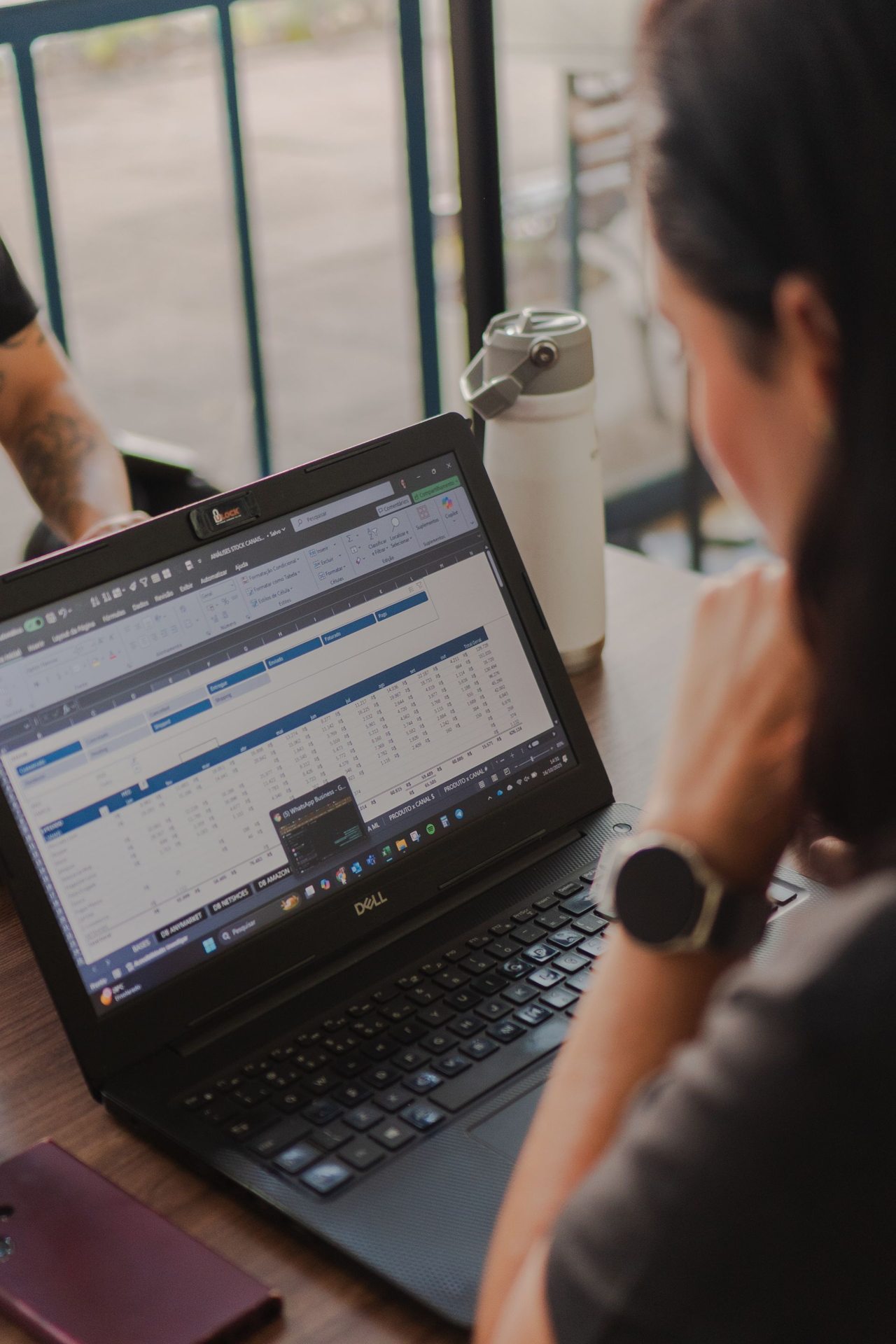 Person analysing customer data on a laptop screen