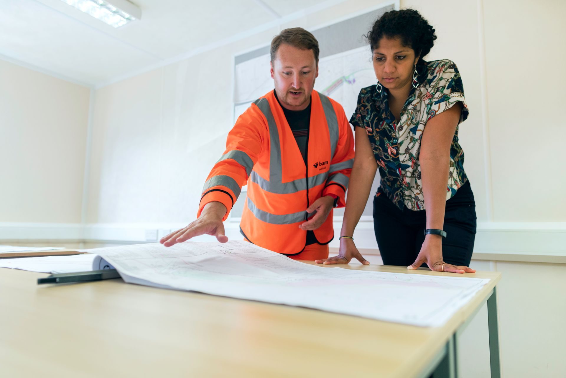 Engineers looking at a blueprint together